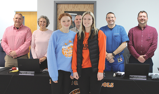 Freshman player Presley Hall, left, and coach Kacie Culbertson represent John I. Burton High School's volleyball team that was recognized at Norton School Board's Feb. 12 meeting. Not pictured are members Savannah Adams, Chloe Branham, Jordan Mooney, Jordan Mullins, Taylor Phipps, Rehgan Sensabaugh, Eden Shortt and Kylee Sturgill. The team finished the season with an appearance at regions while Sturgill reached 1,000 career assists as a junior and Adams reached 1,000 career digs as a senior.  KENNETH CROWSON PHOTO