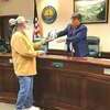 Carlos Fields receives a plaque from Mayor Joe Fawbush upon his retirement. FRED RAMEY PHOTO