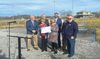 Holding the sports complex check are Wise Mayor Teresa Adkins and Town Manager Laura Roberts. Behind them, left to right, are Virginia Energy official Randy Moore, Congressman Morgan Griffith, Virginia Energy official Daniel Kestner and town council members Ben Conway and Jeff Dotson.  LISA MAINE PHOTO
