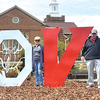 Town of Wise officials pose beside the municipality’s new LOVE sign, unveiled Sunday.   LISA MAINE PHOTO