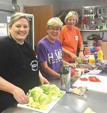 Volunteers, who make up their cook team, prepare a hearty breakfast each morning at 7 am in the church fellowship hall. Afterwards, this team prepares lunches for all work crews. Another group of volunteers then deliver these lunches to each job site.