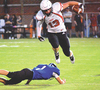 Central’s Ethan Collins vaults over the would-be tackler. PHOTO BY STEPHEN KING