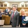 Steven Davis is sworn in as commonwealth attorney while wife Julie and daughter Amelia watch. Standing in the background is Chuck Slemp, who is leaving to work for the new state attorney general.  JESSICA HOOD PHOTO