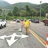 A worker paints traffic directional arrows Thursday morning during the final stages of downtown Norton’s streetscape improvement projects.  FRED RAMEY PHOTO