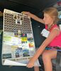 A young girl shows off a Wise County Sheriff’s Office calendar obtained Thursday during a National Night Out event.  LISA MAINE PHOTO