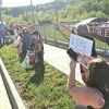With fists raised, protesters try to get the attention of passing motorists. KELLEY PEARSON PHOTO